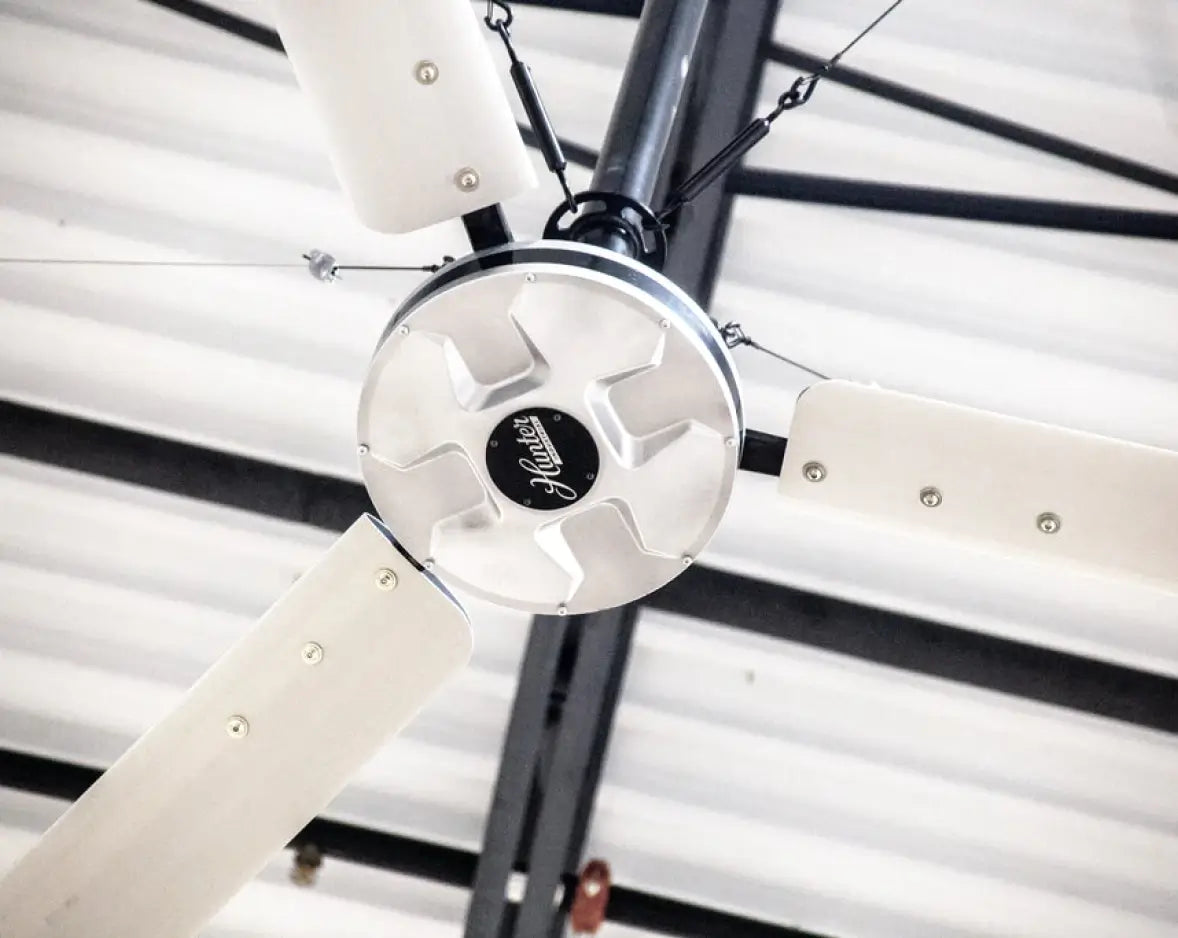 Hunter Industrial DDI HVLS fan mounted to corrugated metal roof structure
