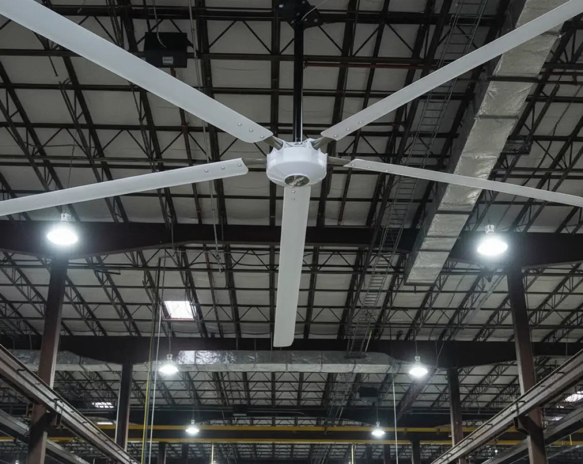 Hunter Industrial Titan HVLS fan in high-bay warehouse with steel truss ceiling